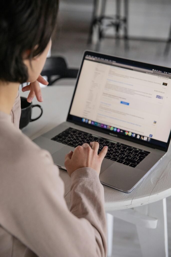 a woman facing her laptop